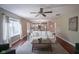 Comfortable living room with hardwood floors, a ceiling fan, a white sofa, and access to kitchen at 17635 Willow Creek Way, Westfield, IN 46074