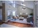 Open-concept living area with hardwood floors, vaulted ceiling, and a staircase leading to the second floor at 17635 Willow Creek Way, Westfield, IN 46074