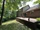 Spacious back deck with chairs and a lush, wooded lot perfect for entertaining at 2002 Grey Fox Ct, Martinsville, IN 46151