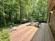 Outdoor patio featuring a wood deck, seating, and overlooking a wooded area at 2002 Grey Fox Ct, Martinsville, IN 46151