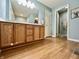 Bathroom featuring wood-look flooring, wooden vanity, and an open doorway at 2002 Grey Fox Ct, Martinsville, IN 46151