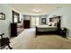 Spacious primary bedroom with carpet flooring, a large bed and dark furniture at 2002 Grey Fox Ct, Martinsville, IN 46151