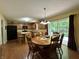 Bright eat-in kitchen features a wooden dining set and backyard view at 2002 Grey Fox Ct, Martinsville, IN 46151