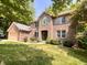 Beautiful brick home with manicured landscaping and green door at 2002 Grey Fox Ct, Martinsville, IN 46151