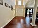 Bright foyer with white columns leads into the dining room with wood floors and natural light at 2002 Grey Fox Ct, Martinsville, IN 46151