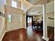 Bright foyer with white columns leads into the dining room with wood floors and natural light at 2002 Grey Fox Ct, Martinsville, IN 46151