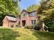 Charming two-story brick home featuring a well-manicured lawn and mature landscaping at 2002 Grey Fox Ct, Martinsville, IN 46151