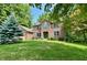 Attractive brick home with green door and shutter accents and mature landscaping at 2002 Grey Fox Ct, Martinsville, IN 46151