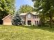 Charming brick home with a well-manicured lawn and mature trees at 2002 Grey Fox Ct, Martinsville, IN 46151