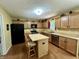 Well-lit kitchen with island, stainless steel appliances, and ample cabinet space at 2002 Grey Fox Ct, Martinsville, IN 46151