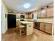 Spacious kitchen features light wood cabinets, stainless steel appliances, and island with breakfast bar at 2002 Grey Fox Ct, Martinsville, IN 46151