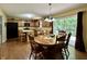 Well-lit eat-in kitchen featuring wooden cabinets, a center island, and sliding glass doors at 2002 Grey Fox Ct, Martinsville, IN 46151