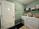 Functional laundry room with modern washer and dryer, plus ample storage baskets at 2002 Grey Fox Ct, Martinsville, IN 46151