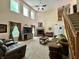Open-concept living room with fireplace, lots of natural light, and staircase at 2002 Grey Fox Ct, Martinsville, IN 46151