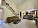 Inviting living room with high ceilings, a staircase, and views into the modern kitchen at 2002 Grey Fox Ct, Martinsville, IN 46151