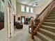 Open living area with high ceilings, fireplace, and staircase at 2002 Grey Fox Ct, Martinsville, IN 46151