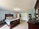 Spacious main bedroom featuring a wooden bed frame, light blue walls, and double closets at 2002 Grey Fox Ct, Martinsville, IN 46151