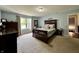 Spacious main bedroom featuring a wooden bed frame, light blue walls, and a big window at 2002 Grey Fox Ct, Martinsville, IN 46151
