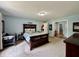 Spacious main bedroom featuring a wooden bed frame, light blue walls, and double closets at 2002 Grey Fox Ct, Martinsville, IN 46151