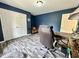 Blue office features wood-look floors, desk, and chair at 2002 Grey Fox Ct, Martinsville, IN 46151