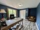 Office with a desk, hardwood floors, and dark blue walls at 2002 Grey Fox Ct, Martinsville, IN 46151