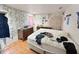 Bright bedroom featuring wood floors and custom wallpaper, offering a unique aesthetic at 2074 W 300 S, Shelbyville, IN 46176