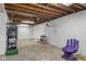 Spacious basement with painted walls and exposed ceiling with storage at 2233 Washington St, Columbus, IN 47201