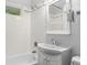 Bright bathroom features tiled walls, a shower-tub combo, vanity with storage, and a modern toilet at 2233 Washington St, Columbus, IN 47201