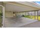 Carport attached to home with concrete floor and seating area at 2233 Washington St, Columbus, IN 47201