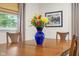 Close-up of the dining table with a blue vase filled with beautiful flowers and a wooden table at 2233 Washington St, Columbus, IN 47201