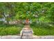 Exterior home view showcasing the inviting entrance with stone steps and beautiful landscaping at 2233 Washington St, Columbus, IN 47201