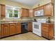 Functional kitchen featuring wooden cabinets, neutral countertops and essential appliances for easy meal preparation at 2233 Washington St, Columbus, IN 47201