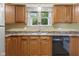 Well-lit kitchen showcasing wood cabinets and neutral countertops, creating a clean and efficient cooking space at 2233 Washington St, Columbus, IN 47201