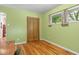 Room features hardwood floors, a window view, a textile wall hanging and green painted walls at 2233 Washington St, Columbus, IN 47201