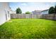 Large backyard with wooden fence and green grass, perfect for outdoor activities and entertaining at 2388 Cedarmill Dr, Franklin, IN 46131