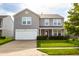 Charming two-story home with a two car garage, well-maintained lawn, and inviting front porch at 2388 Cedarmill Dr, Franklin, IN 46131
