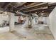 Unfinished basement space with exposed beams and utilities, ready for customization at 2433 E 16Th St, Indianapolis, IN 46201
