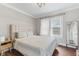 A cozy bedroom with a tufted headboard, neutral tones, and great natural light at 2433 E 16Th St, Indianapolis, IN 46201