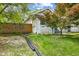Home featuring a cozy front yard with lush greenery, stone accents, and a welcoming pathway at 2433 E 16Th St, Indianapolis, IN 46201