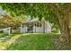 Inviting home boasting a covered porch with mature trees, and green lawn at 2433 E 16Th St, Indianapolis, IN 46201