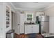 A practical kitchen featuring white cabinets, a stainless steel refrigerator, and a pantry at 2433 E 16Th St, Indianapolis, IN 46201