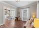 Bright room featuring beautiful hardwood floors, decorative trim, and open flow to dining area at 2433 E 16Th St, Indianapolis, IN 46201