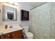 Bright bathroom featuring wood vanity, toilet, and patterned shower curtain at 29 Northview Dr, Danville, IN 46122