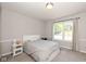 Minimalist bedroom with a white bed, streamlined furniture, and lots of natural light at 29 Northview Dr, Danville, IN 46122