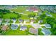 Wide aerial view of a residential neighborhood near open fields, streets and commercial property at 32 Downing Dr, Trafalgar, IN 46181