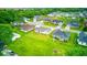 Aerial view of a suburban neighborhood, featuring various houses with lush green lawns at 32 Downing Dr, Trafalgar, IN 46181