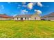 Backyard of house with large grassy field and clear blue sky at 32 Downing Dr, Trafalgar, IN 46181