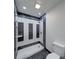 Modern bathroom featuring tiled shower with decorative black and white tiling at 32 Downing Dr, Trafalgar, IN 46181
