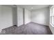 Unfurnished bedroom with neutral walls, grey carpet, and a double closet at 32 Downing Dr, Trafalgar, IN 46181