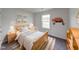 Staged bedroom with wooden bed frame, and decoratively decorated walls at 32 Downing Dr, Trafalgar, IN 46181